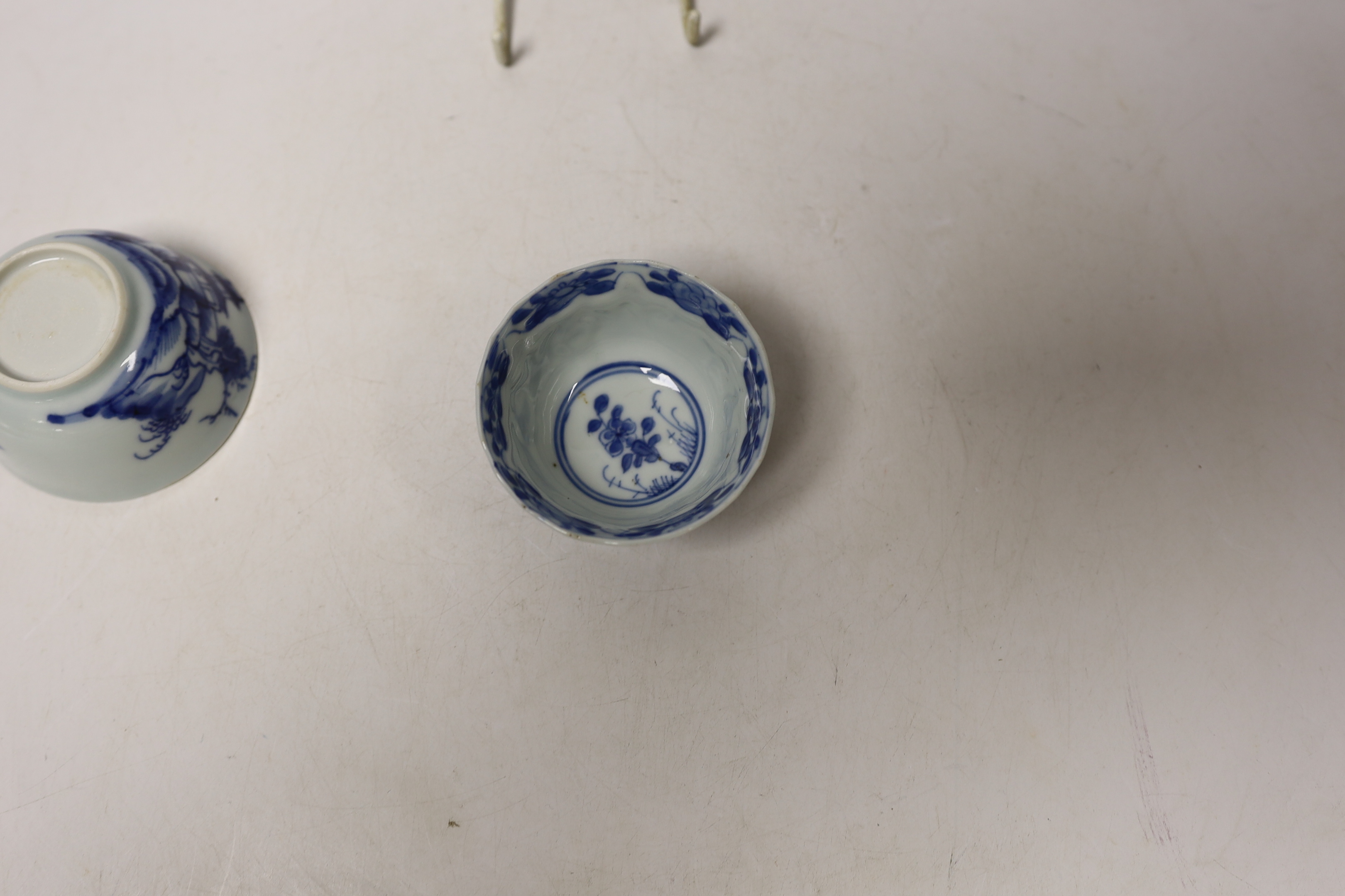 A Chinese Nanking Cargo blue and white saucer and tea bowl, and a Kangxi blue and white tea bowl, largest 11.5cm in diameter